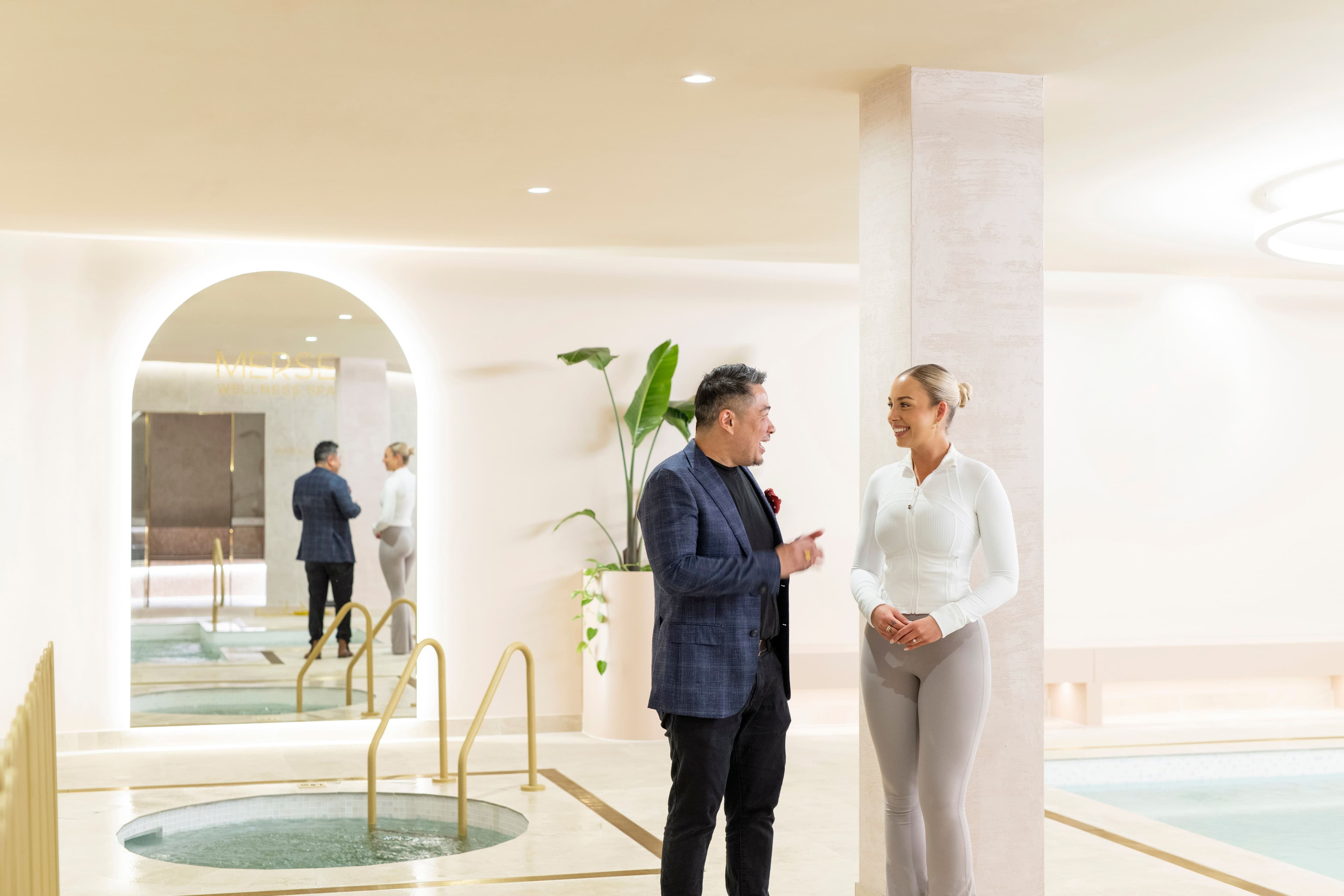 Interior designers consulting in a wellness space, with an interior decorator reviewing layout and design details on site